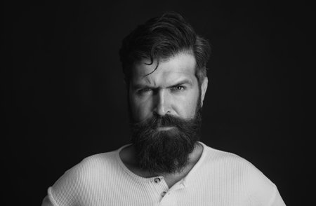 Young handsome man with long beard, mustache and trendy hairdo.の写真素材
