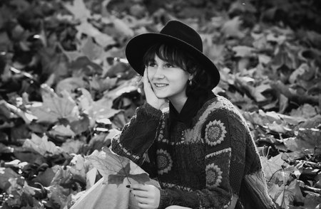 Autumn walk. Dreamy beautiful girl with natural black hair on autumn background with colorful...
