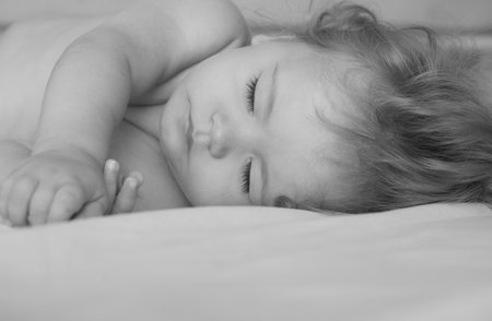 Baby sleeping in the bed. Quiet sleep, sleeping cute child.の写真素材