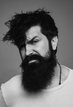 Man haircut, modern hair style. Close up portrait of male model with long hair. Healthcare and hair care concept. Bearded hipsterの写真素材