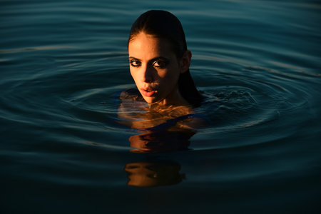 Summer portrait. Sensual girl in water. Beauty woman. Fashion portraitの写真素材