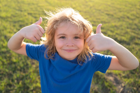 Lifestyle portrait of funny kid outdoors. Summer kids outdoor portrait. Close up face of cute child....