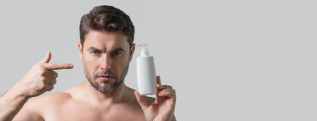 Cosmetic products. Beauty man presentation cosmetic bottle, cream. Natural cosmetics cream, spa beauty products. Man advertising cosmetic. Banner for header, copy space. Poster for web design.の写真素材