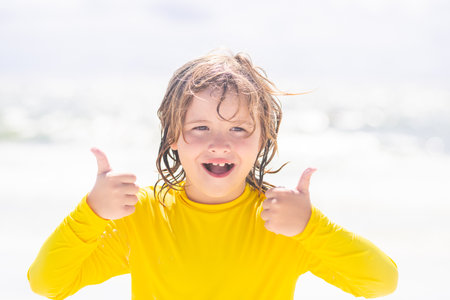 Happy child playing in the summer sea. Kid having fun at the beach. Summer vacation and kids active....