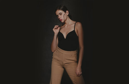 Fashion shot. Vogue model posing at studio. Collection of fashion clothes. Model in style trends...