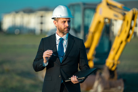 Engineer, construction manager or supervisor at a construction. Supervisor in suit and helmet....