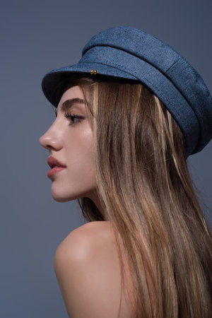 Seductive woman face. Sensual young woman posing in fashion cap hat. Beautiful sexy model. Beauty face. Sensual girl, sexy model portrait. Natural beauty.の写真素材