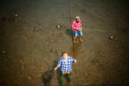 Men hobby and recreation. Fishermen successful catch fish. Fisher retirement. Retired businessman in...