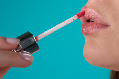 Close up woman applying red lipstick on lips. Sexy girl applied lipstick. Red lips lipstick make up. Putting lipstick on lips.の写真素材