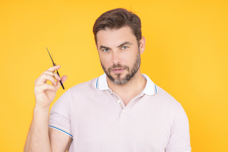 Man with barbers scissors. Man cut hair with hairdressing scissors. Men haircut in barbershop. Barber scissors. Mens haircut. Barber holding scissors. Barber tools. Barber shop.の写真素材