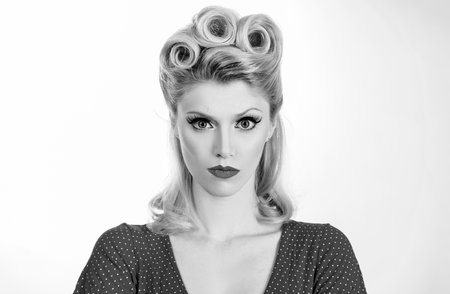 Portrait of a serious blonde woman over white background.の写真素材