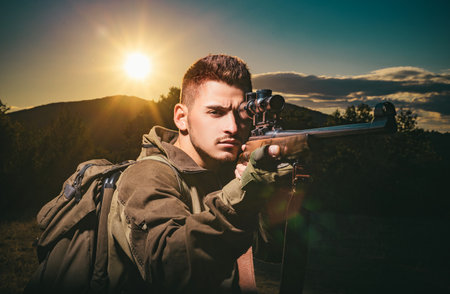 Close up snipers carbine at the outdoor hunting. Hunter aiming rifle in forest. Hunter with shotgun gun on hunt. Hunter in the fall hunting season.の写真素材