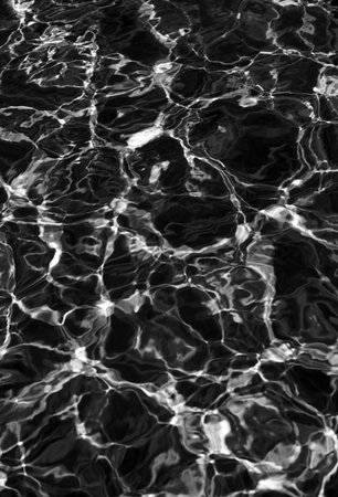 Ripple Water in swimming pool with sun reflection. Wavy water background.の写真素材