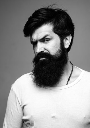Portrait of confident serious man. Hipster guy models in studio. Handsome male model on gray...