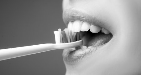 Woman mouth brushing teeth. Beautiful smile of young woman with healthy white teeth. Isolated...