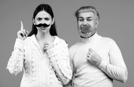 Identity transgender, gender stereotypes. Woman with moustache and man with red lips. Couple gender equality.の写真素材