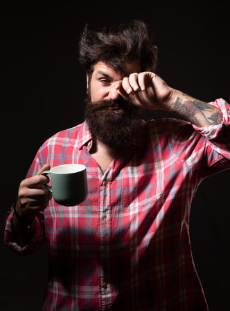 Happy morning. Mans holds cup of coffee. Morning tea. Good morning. Man with tea cup. Hipster man with cup of coffee. Bearded man smiling hold mug tea. Wake up. Happy day. After morning tea.の写真素材