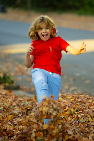 Child Playtime in the Park. Autumnal Wonders. Capturing Childhood Joy in the Park. Child Enjoying Autumn in the Park. Fall Foliage. Kid in the Park. Child with Nature.の写真素材