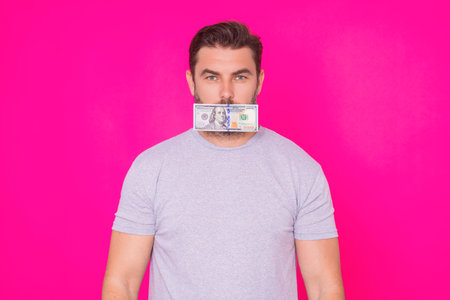 Business man hold money on pink studio isolated background. Rich man in t-shirt with money dollar...