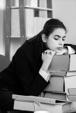 Sadness depressed businesswoman, frustration secretary girl, stressed employee with folders with the documents working overtime with too much work, business problem.の写真素材