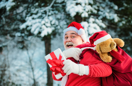 Santa Claus with huge red sack. Merry Christmas and New Year Eve concept.の写真素材