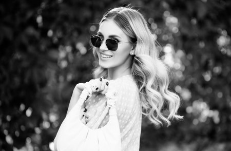 Beautiful young woman, tender girl in sunglasses. Fashion and beauty. Young woman on sunny summer day. Lifestyle, walk outdoors, enjoying life, positivity.の写真素材