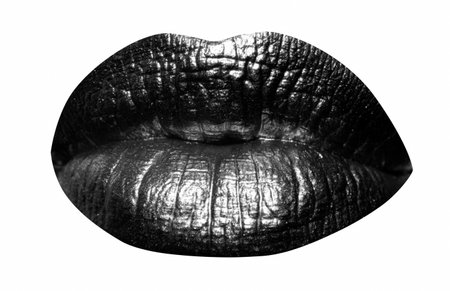 Golden lips closeup. Lip with metal gold maetallic kipstick. Sexy girl golden mouth. Isolated on white background, clipping path.の写真素材