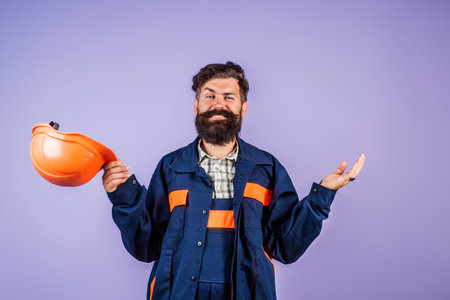 Engineer man, builder with building equipment. Safety helmet. Renovation. Man in hardhat. Heavy work. Labor day. Builder working. Hard job. Construction man, worker contractor foreman workman.の写真素材