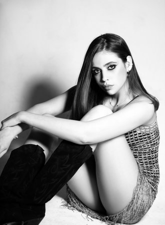 Young glamour woman wearing stylish fashion dress. Fashion model in studio. Beauty model, style and...