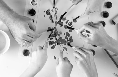 Fathers, mothers hands with children hands painting and drawing. Top view.の写真素材