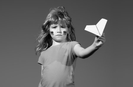 Close the sky over Ukraine banner. No fly zone over Ukraine. Ukraine flag on kids cheek.の写真素材