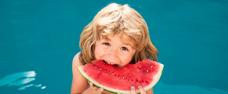 Funny amazed child eats watermelon near the pool. Banner for header, copy space. Poster for web design.の写真素材