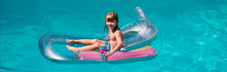 Kids happy summer. Summertime vacation. Child in pool. Boy swimming at swimmingpool. Funny kid on...