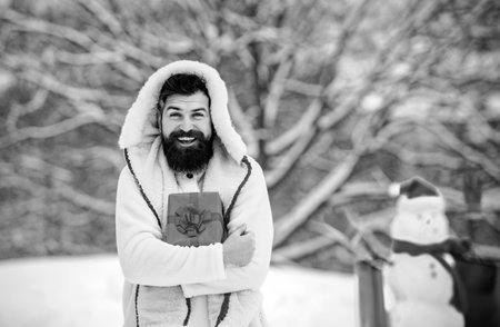 Man in Christmas dress with gift near the Christmas background. Man in Christmas dress with gift...