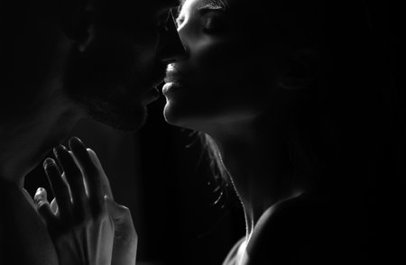 Close up face of a beautiful young couple in love embracing, romance and and affection. Sensual couple kiss. I love you. Romantic and love.の写真素材