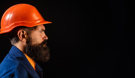 Builder worker in construction helmet. Builder foreman or repairman in builders uniform. Worker in studio. Construction manager, builder in helmet. Male builder engineer.の写真素材