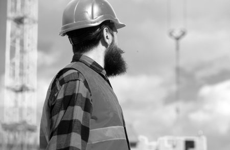 Construction worker man in work clothes and a construction helmet. Industrial theme.の写真素材