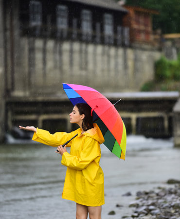 Rainy day. Funny woman hold umbrella with rainy water drops. Girl under falling water drops in rainy season. Woman with umbrella. Summer rain. Rainy weather. rain rain go away.の写真素材