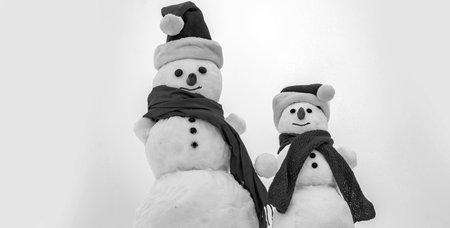 Funny Snowmen. Two snowman on snow background.の写真素材