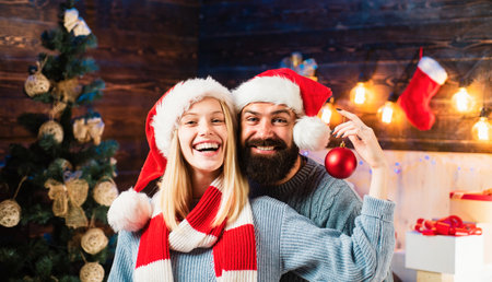 Loving family. Merry Christmas and Happy New Year. Happy holidays couple celebrate and decorate the house. New Years decorations for holidays and home. Christmas together.の写真素材