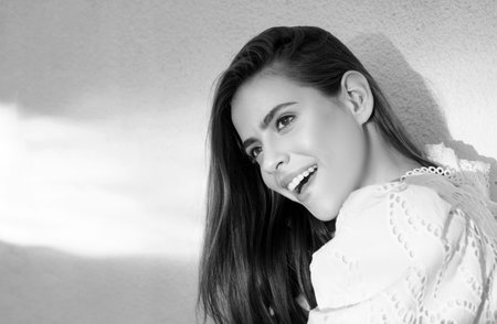 Spring romantic casual woman portrait. Beautiful young woman outdoors. Sunny day. Nature summer background. Outside close-up portrait of beautiful young happy woman with fresh and clean skin.の写真素材