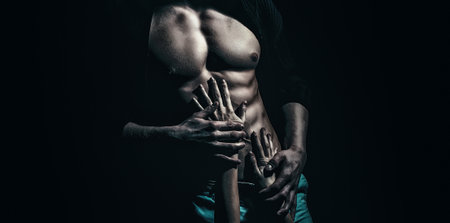 Sexy male model with bare nude torso. Sexy young handsome naked man on dark background. Seductive gay.の写真素材