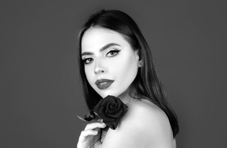 Portrait of attractive woman beauty girl with red rose.の写真素材