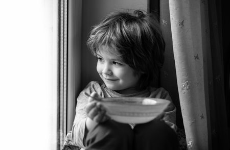 Kid eating breakfast. Child eating healthy food.の写真素材