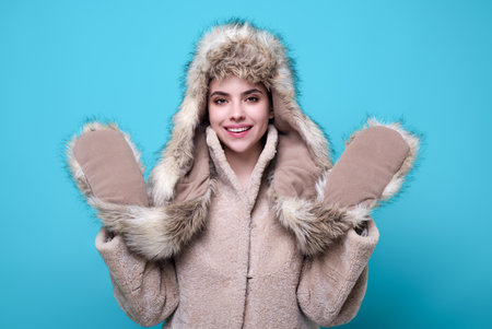 Woman in winters warm winter cloth. Young woman in winter coat knitted sweater scarf and hat. Winter...