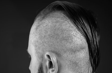 Close up male haircut. Hairstylist bold head. Barbershop concept. Man barber hairstylist.