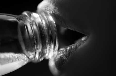 Woman mouth drinking water from bottle. Close up drink water. Sensual lips.の写真素材