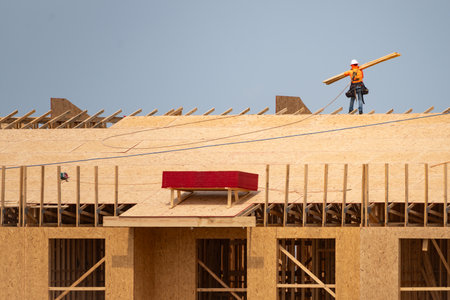 Roofing construction. Roofer roofing on roof structure. Roofing Wooden House Frame. Worker roofer builder working on roof at construction site. Construction builders Roofing.の写真素材
