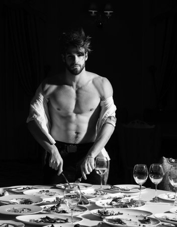 Man at restaurant. Diet guy with bare torso, choice between healthy and unhealthy food. Shirtless man food delicious. Assorted food on table. Dinner gourmet cuisine catering food concept.の写真素材