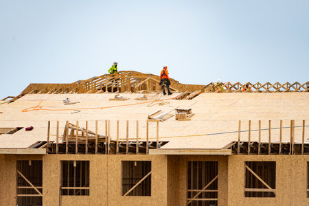 Wooden roof beam from framework. House roof at construction site. Roofer working on roof structure of building on construction site. Wooden roof beams.の写真素材